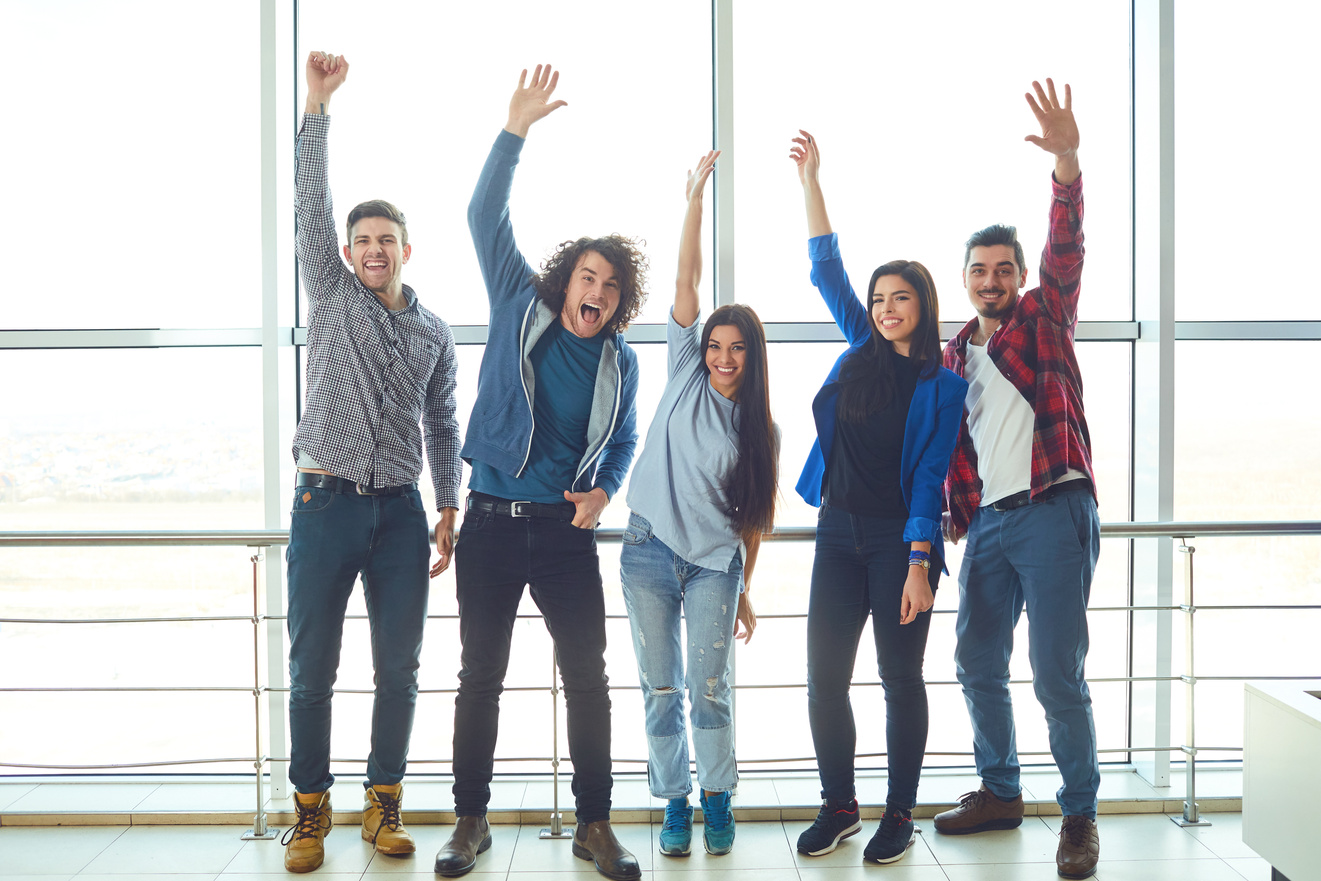 Young People Raised Hands up against the Window